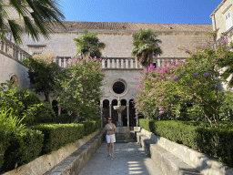 Miaomiao with a fountain at the garden of the Franciscan Monastery