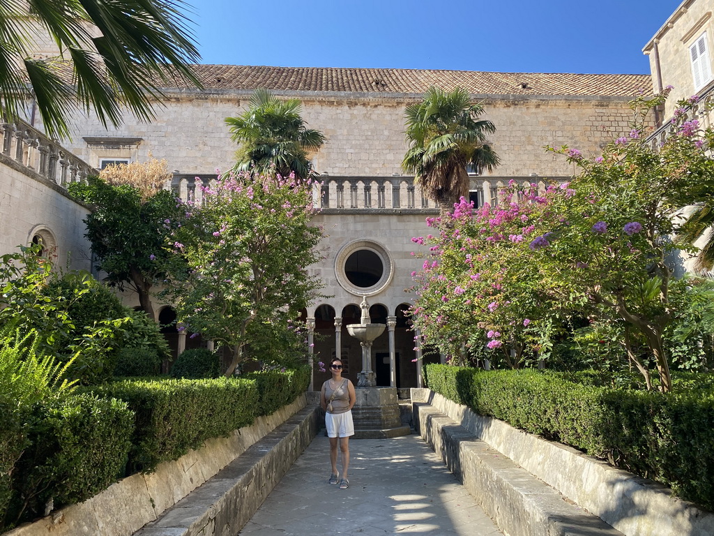 Miaomiao with a fountain at the garden of the Franciscan Monastery