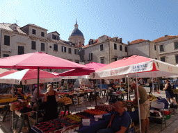 Market stalls and the statue of Ivan Gundulic at the Gunduliceva Poljana market square and the dome of the Dubrovnik Cathedral