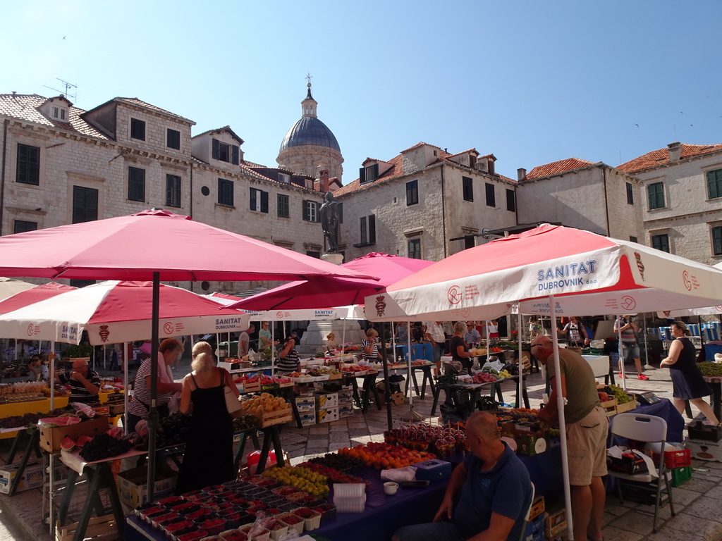 Market stalls and the statue of Ivan Gundulic at the Gunduliceva Poljana market square and the dome of the Dubrovnik Cathedral