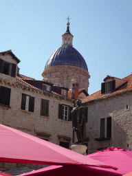 The statue of Ivan Gundulic at the Gunduliceva Poljana market square and the dome of the Dubrovnik Cathedral