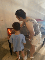 Miaomiao and Max lighting a candle at the Church of St. Ignatius