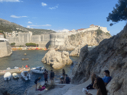 Pier and boats at the Dubrovnik West Harbour, the western city walls, the Tvrdava Bokar fortress, Kolorina Bay and kayaks at Bokar Beach, viewed from the staircase to the park just below Fort Lovrijenac