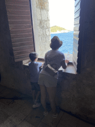 Miaomiao and Max at a window at the backstage area of the theatre at the ground floor of Fort Lovrijenac, with a view on the Lokrum island