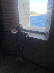 Max at a window at the backstage area of the theatre at the ground floor of Fort Lovrijenac, with a view on the Lokrum island
