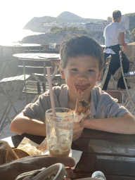 Max having an ice cream at the terrace of the Caffe on the Wall restaurant at the top of the Kula sv. Petra fortress, with a view on Fort Lovrijenac and the Velika Petka Hill