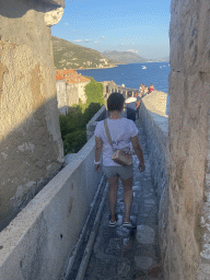 Miaomiao walking through the gate from the top of the Kula sv. Petra fortress to the southern city walls