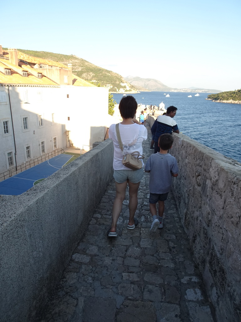 Miaomiao and Max on top of the southern city walls, with a view on the Kula sv. Margarita fortress, a sports field at the back side of the Collegium Ragusinum building and the Lokrum island