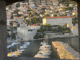 Window at the top of the Tvrdava Svetog Ivana fortress, with a view on the Old Port and the Revelin Fortress