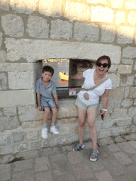 Miaomiao and Max at a window at the top of the Tvrdava Svetog Ivana fortress, with a view on an old ship