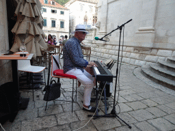 Musician at the west side of St. Blaise`s Church at the Zeljarica Ulica street