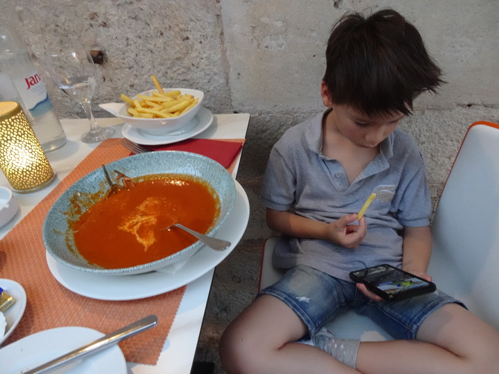 Max eating soup and fries at the terrace of the Konoba Saint Blaise restaurant at the Zeljarica Ulica street