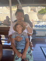 Miaomiao and Max on the ferry to the Lokrum island, with a view on the Old Port and the Kula sv. Luke fortress