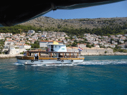 Ferry in front of the east side of the city with the Lazareti Creative Hub of Dubrovnik, viewed from the ferry to the Lokrum island