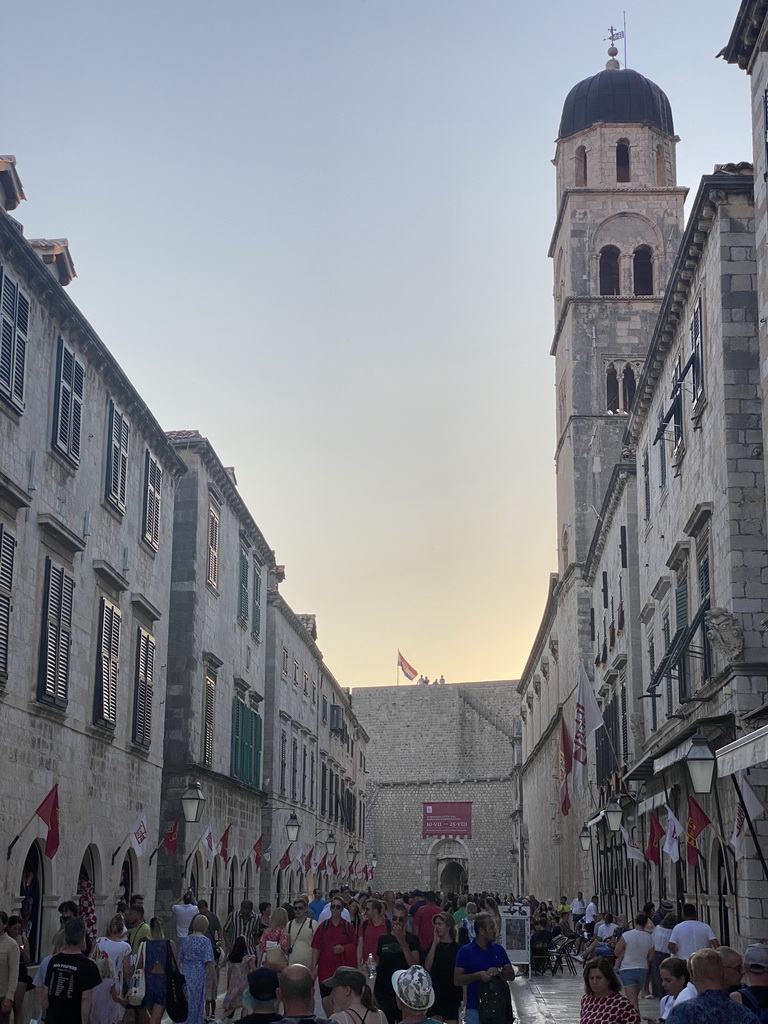 The west side of the Stradun street with the tower of the Franciscan Church