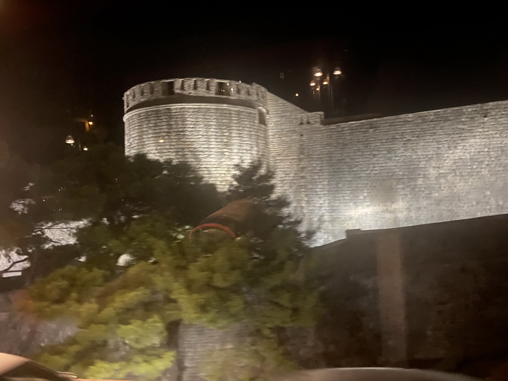 The northern city walls with the Kula sv. Jakov fortress, viewed from the tour bus from Perast on the Ulica Maria Perica street, by night