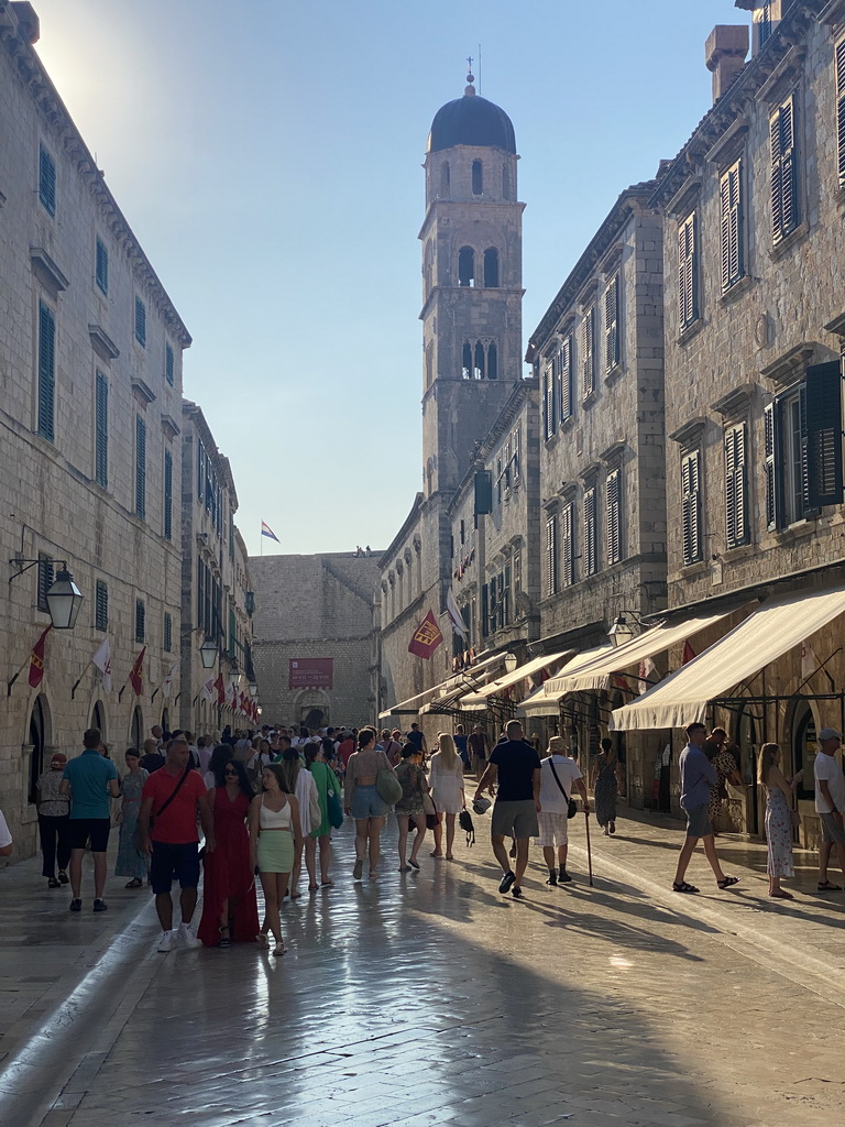 The west side of the Stradun street with the tower of the Franciscan Church