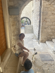 Miaomiao and Max with a cat in front of the entrance to the Ethnografic Museum Rupe at the Ulica od orte street