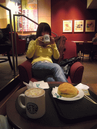 Miaomiao drinking coffee in a Starbucks store