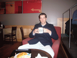 Tim drinking coffee in a Starbucks store