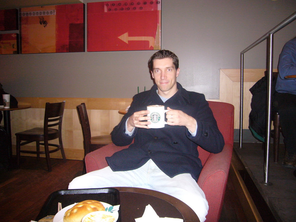 Tim drinking coffee in a Starbucks store