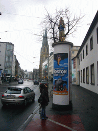 Miaomiao at an advertisement pillar in the Oststraße street, with the Marienkirche church