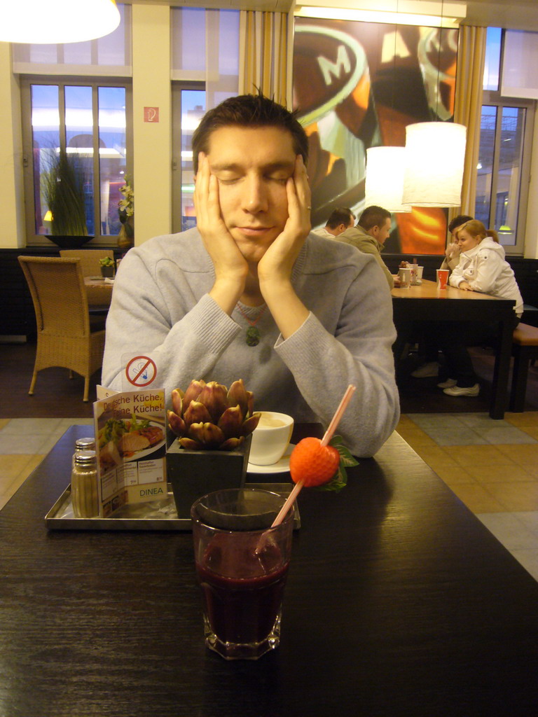 Tim with a coffee in a restaurant