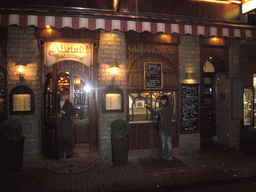 Miaomiao at the front of the Altstadt Restaurant, by night