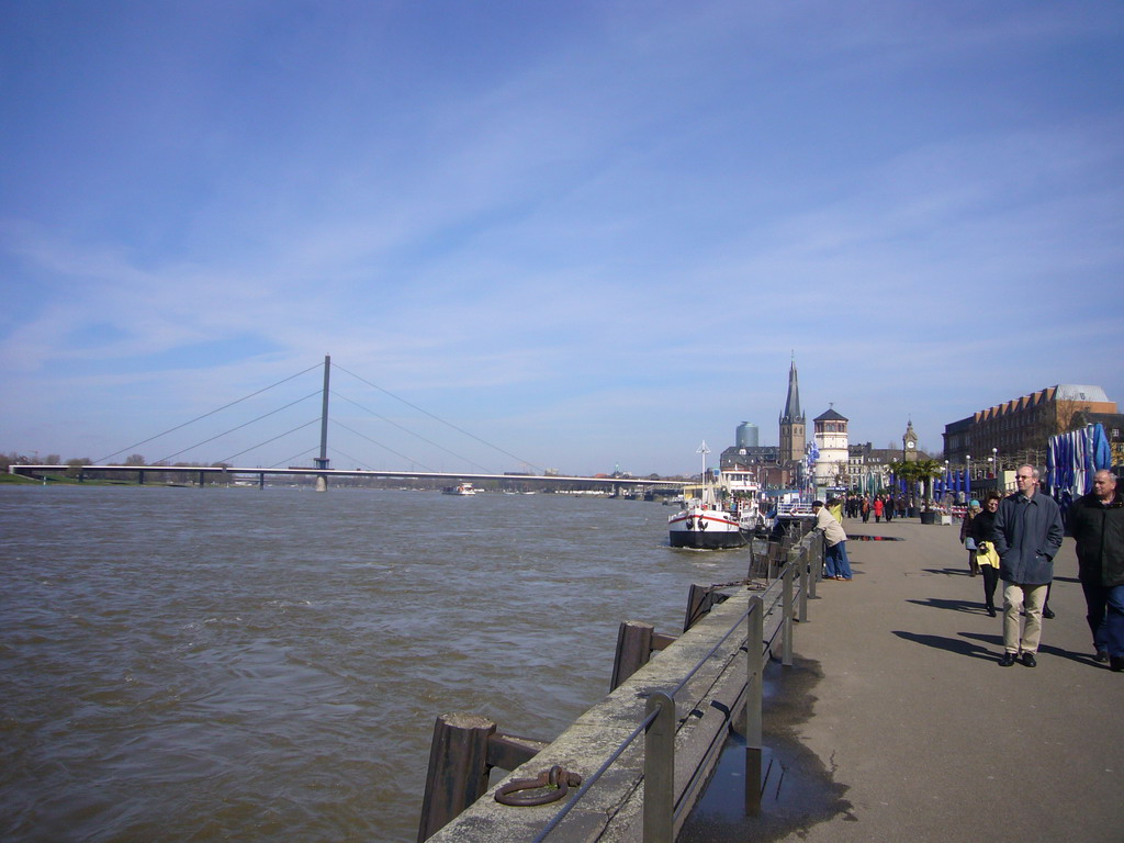 The Rhine shore, with a view on the Oberkasseler Brücke bridge, the Pegeluhr clock, the Old Castle Tower and the Lambertuskirche church