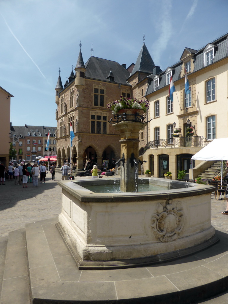 Fountain, the front of the Palace of Justice and the front of the City Hall at the northeast side of the Place du Marché square