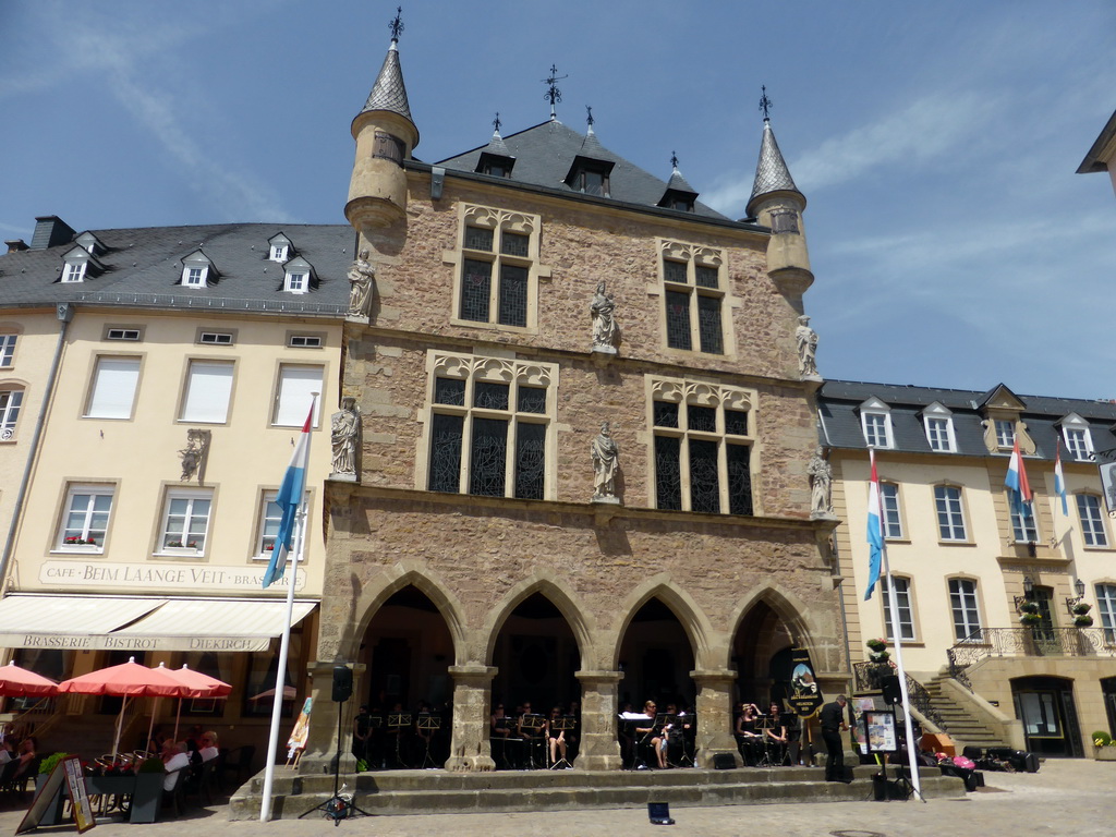 Orchestra playing music at the front of the Palace of Justice at the Place du Marché square