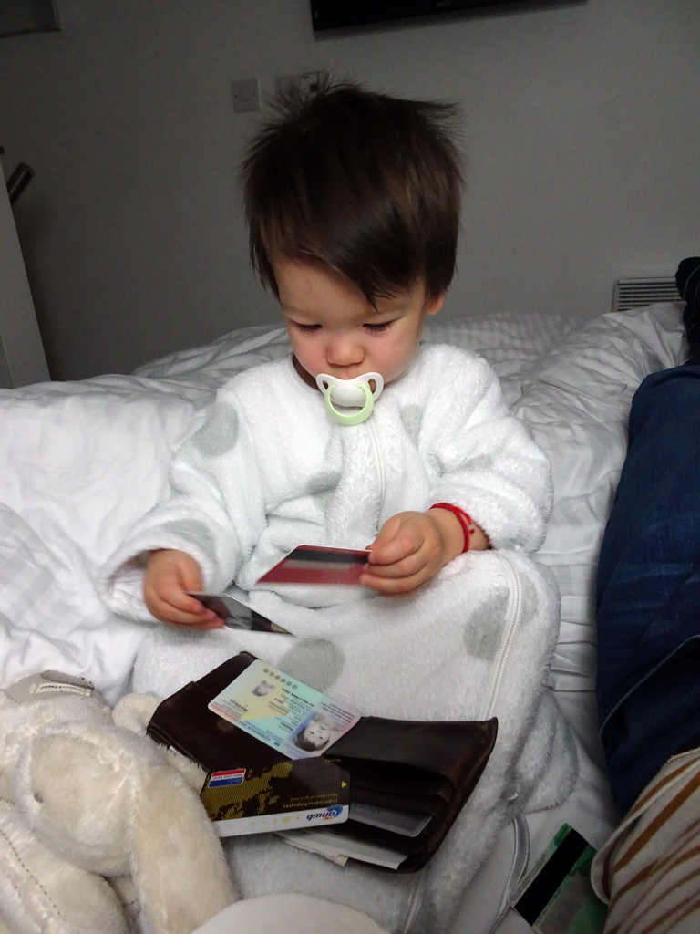 Max playing with Tim`s wallet on the bed of our first apartment at Richmond Place Apartments
