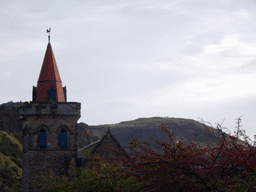 The tower of the Kirk O` Field church and Holyrood Park with Arthur`s Seat, viewed from Richmond Place