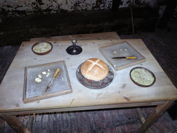 Table with food in a prison cell at the Prisons of War Exhibition building at Edinburgh Castle