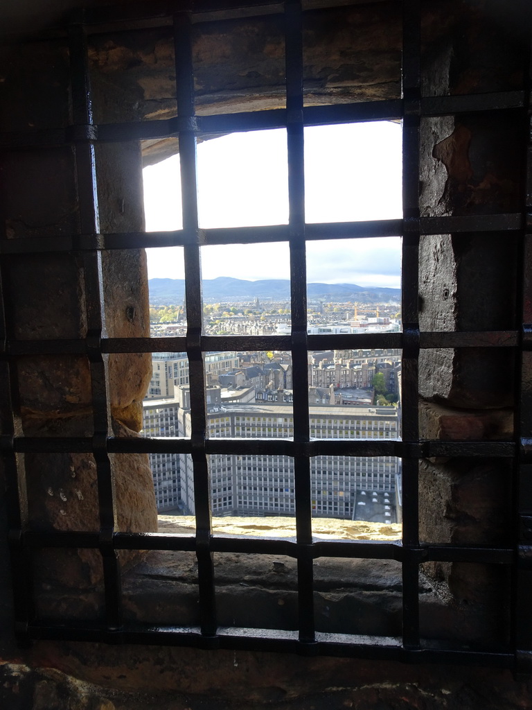 A window at Dury`s Battery at Edinburgh Castle, with a view on the southwest side of the city