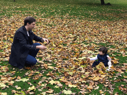 Tim and Max playing with leaves at the Princes Street Gardens