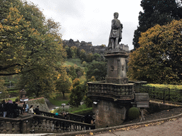 Staircase, the Greenkeeper`s Cottage and the statue of Allan Ramsay at the northeast side of the Princes Street Gardens, with a view on Edinbuirgh Castle