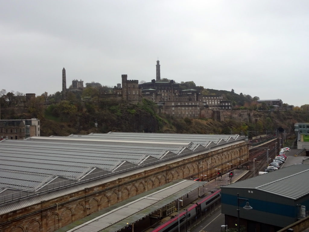 The Edinburgh Waverley railway station and Calton Hill with the the Dugald Stewart Monument, the City Observatory, the National Monument of Scotland, the Nelson Monument, and the Old Calton Burial Ground with the Political Martyrs` Monument, viewed from North Bridge