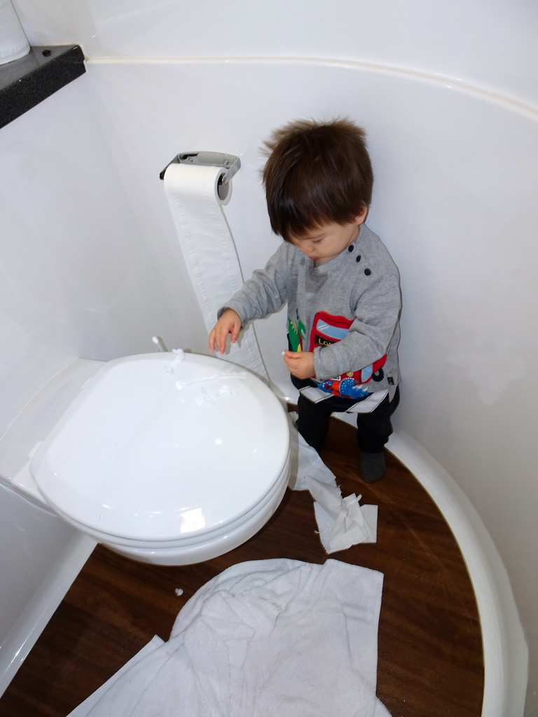 Max playing with toilet paper in the bathroom of our second apartment at the Richmond Place Apartments