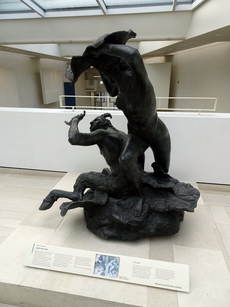 Statue `Nymph and Faun` by Charles Hodge Mackie, at the entrance to the Industry and Empire Hall at the Fifth Floor of the National Museum of Scotland, with explanation