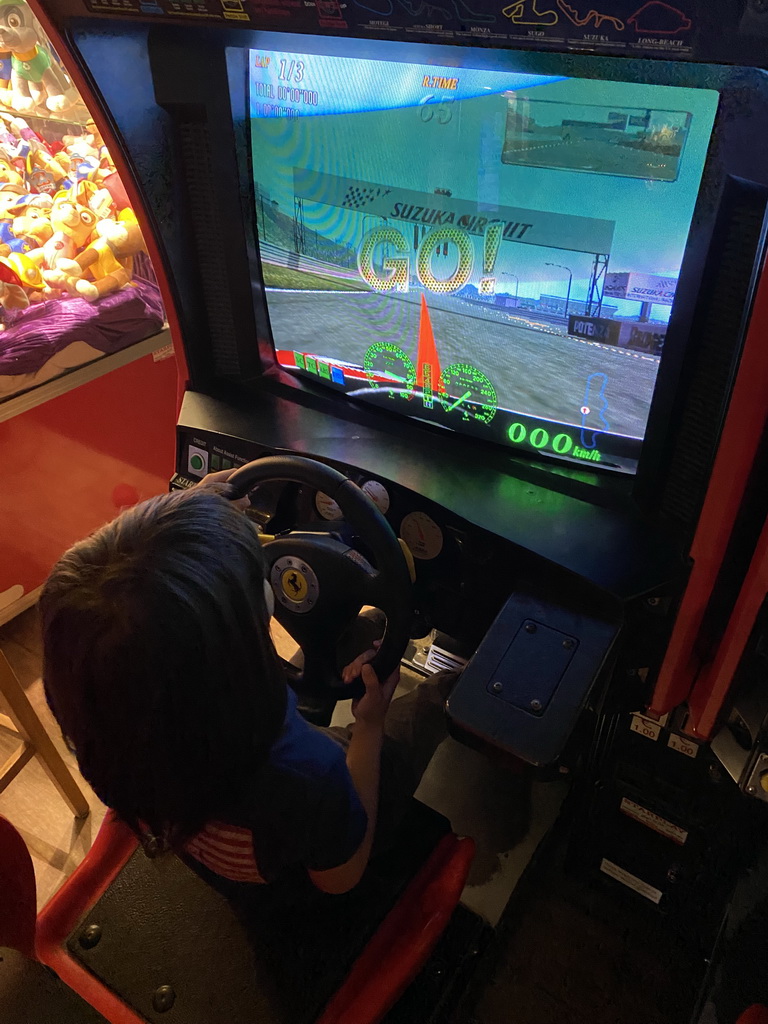 Max playing a racing game at the indoor playground at the Landal Coldenhove holiday park