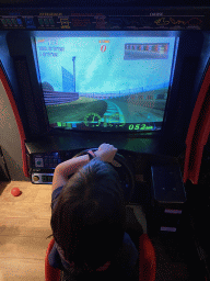 Max playing a racing game at the indoor playground at the Landal Coldenhove holiday park