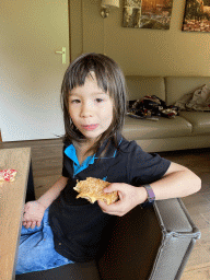 Max eating an appelflap and a donut in the living room of our holiday home at the Landal Coldenhove holiday park