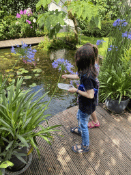 Max and his cousin feeding the fishes at the pond in the garden of the house of Tim`s father at Brummen