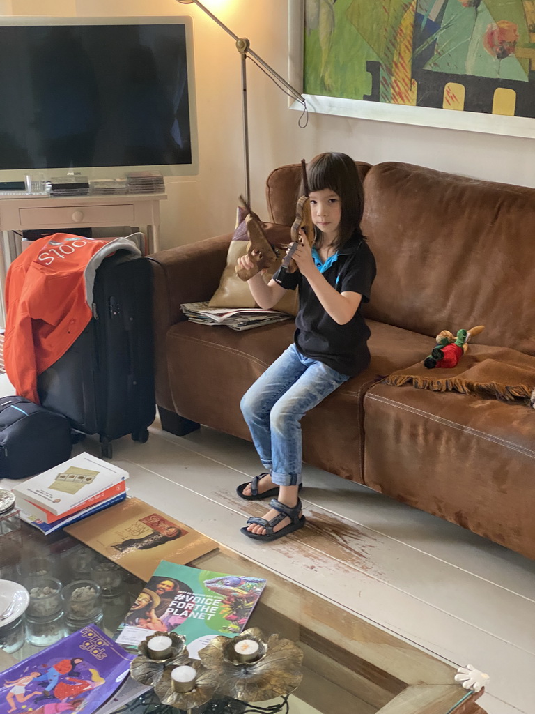 Max with toy guns in the living room of the house of Tim`s father at Brummen