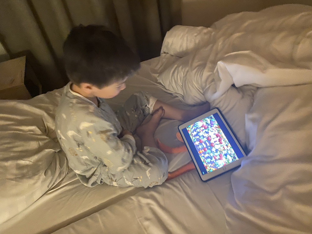 Max watching iPad on his bed in the first bedroom of our holiday home at the Landal Coldenhove holiday park