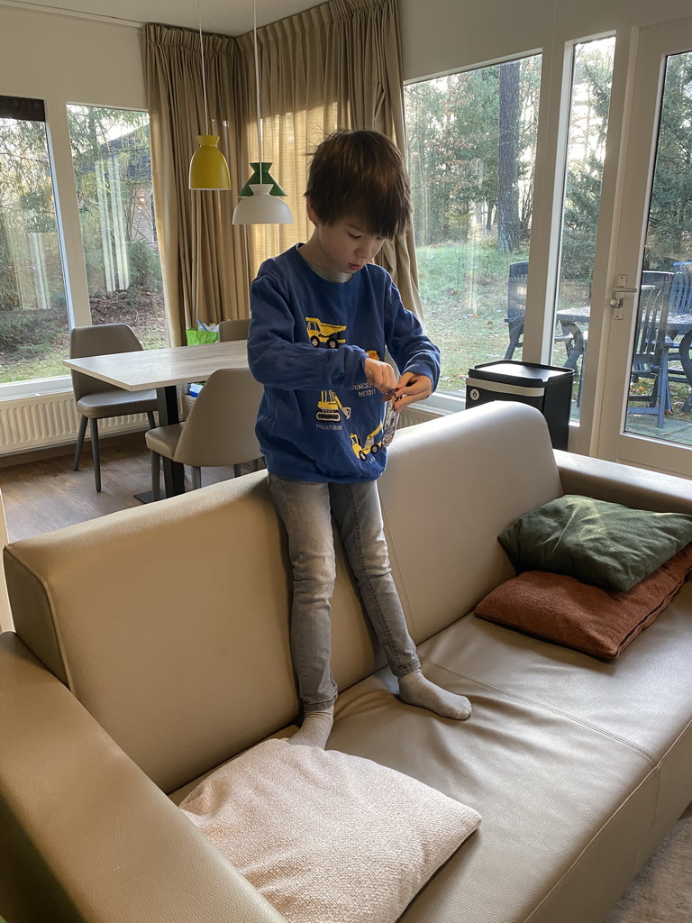 Max opening a pack of Pokémon cards in the living room of our holiday home at the Landal Coldenhove holiday park