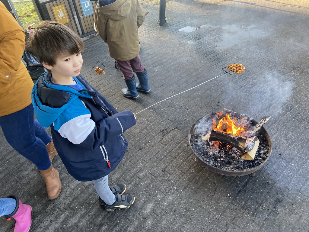 Max baking a waffle above the campfire at the Landal Coldenhove holiday park