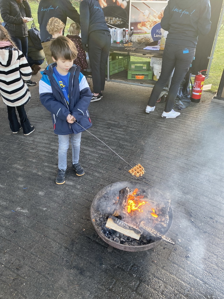 Max baking a waffle above the campfire at the Landal Coldenhove holiday park