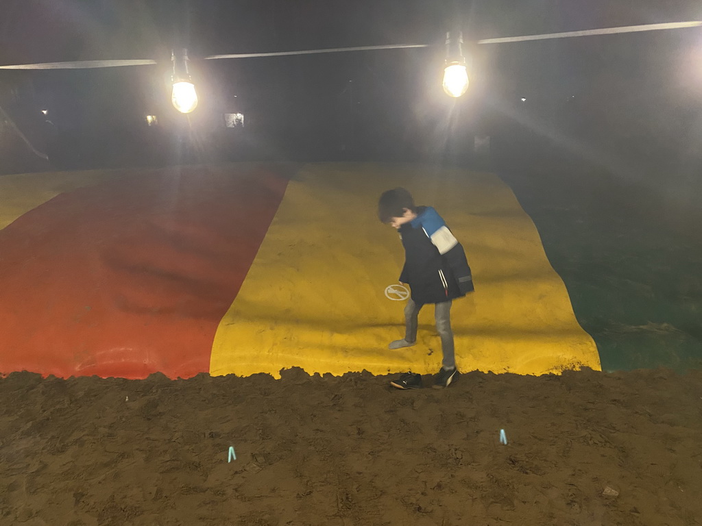 Max on the trampoline at the main playground at the Landal Coldenhove holiday park, by night